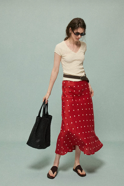 Full-length view of a red polka dot linen skirt with a gently flared hem