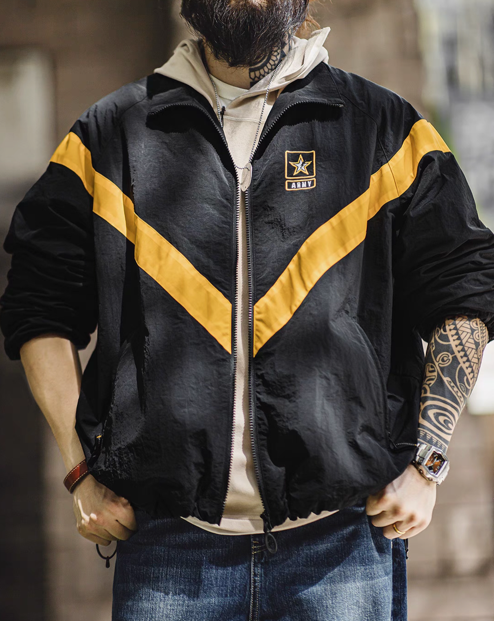 Man wearing Black Reflective V-Stripe Tactical Zip Jacket layered over a hoodie highlighting relaxed fit and bold reflective V-stripe design