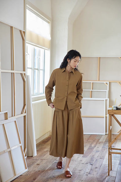 Full-body front view of Earth Tone long-sleeve cotton set, showcasing relaxed silhouette, gathered skirt, and clean tailored lines