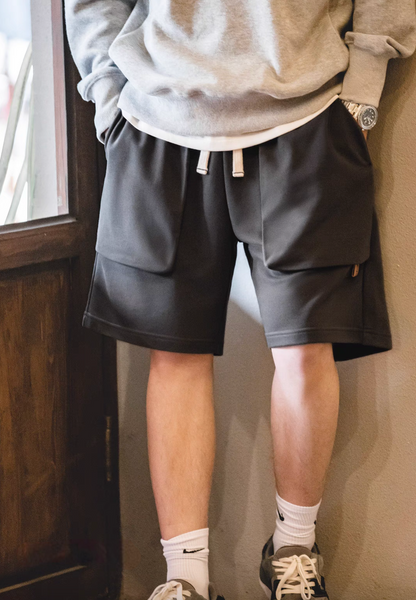 Relaxed Fit Utility Shorts with Deep Pocket Design dark gray indoor lifestyle view showing relaxed comfort fit