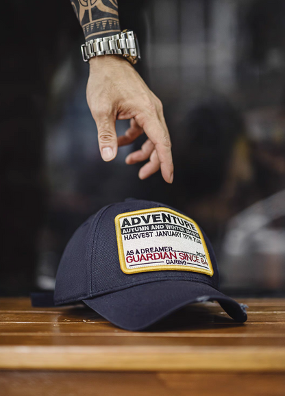 Retro Explorer Cap dark blue close-up with hand reaching highlighting embroidered patch cotton twill texture and structured front panel