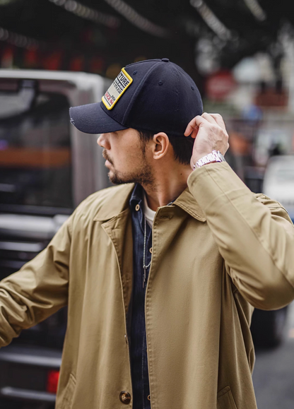 Side profile of Retro Explorer Cap dark blue worn outdoors featuring curved brim structured crown and adjustable strap design