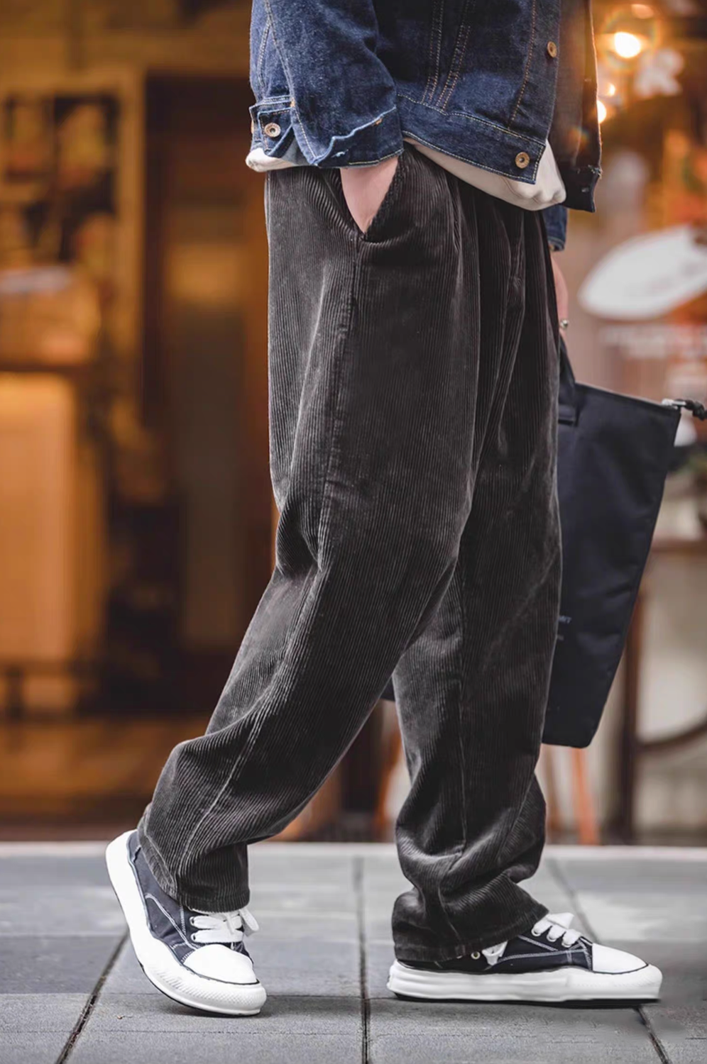 Model walking in Retro Grove Cord Pants in Dark Coffee featuring rich corduroy texture, straight-leg fit, and relaxed casual streetwear styling