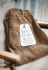 Folded Retro Grove Cord Pants in Khaki showcasing soft corduroy texture, structured waistband, and premium fabric detail
