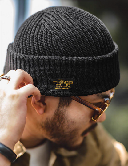Black Retro Knit Beanie side close up showing ribbed knit texture and vintage style label detail