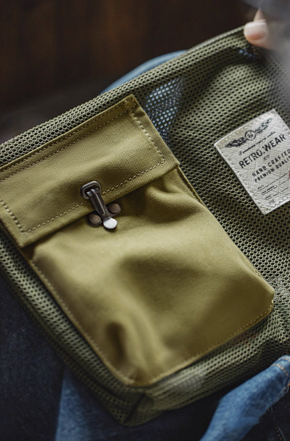 Close-up of RETRO.WEAR label and mesh texture on Army Green bag