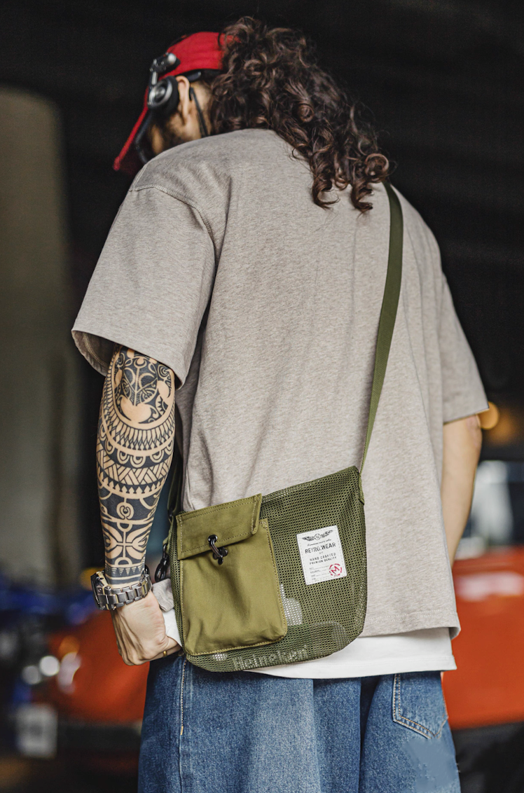 Model wearing Army Green mesh crossbody bag with red cap and casual outfit