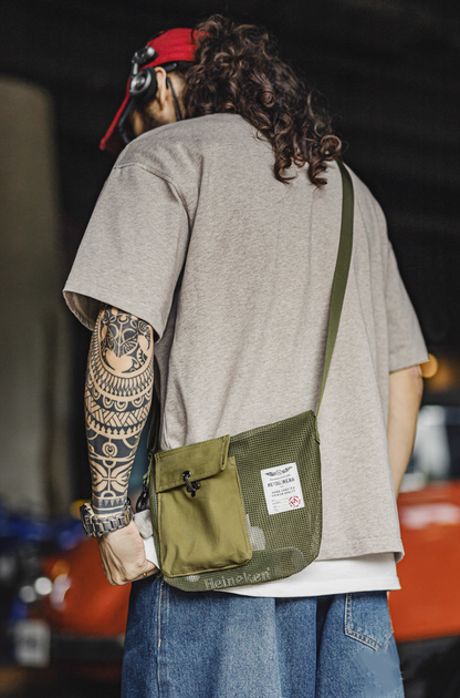 Model wearing Army Green mesh crossbody bag with red cap and casual outfit
