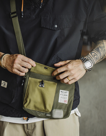 Model wearing vintage Army Green crossbody bag across chest with casual outfit