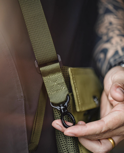 Adjustable shoulder strap and black metal hook detail on Army Green bag