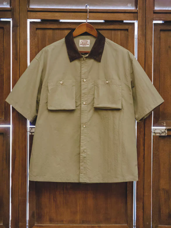 Retro waterproof utility shirt in khaki green front view with button closure dual chest patch pockets and corduroy collar