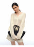 Close-up of ivory ribbed V-neck raglan cardigan with bag