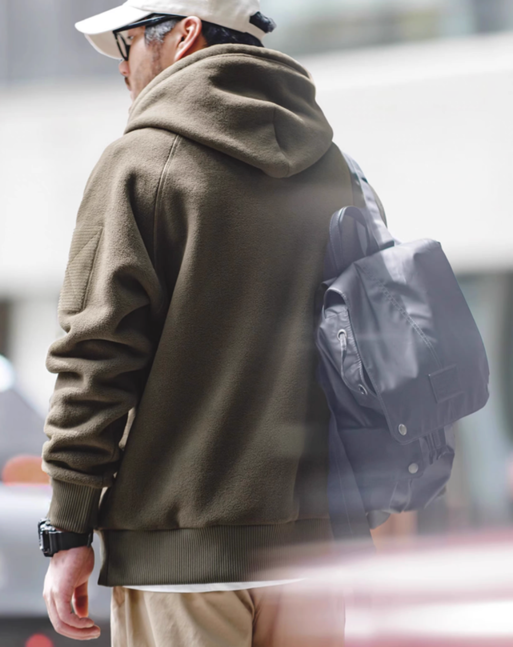 Back view of RidgeLine Fleece Hoodie in olive green showing hood shape, ribbed hem, and clean minimal design for versatile styling