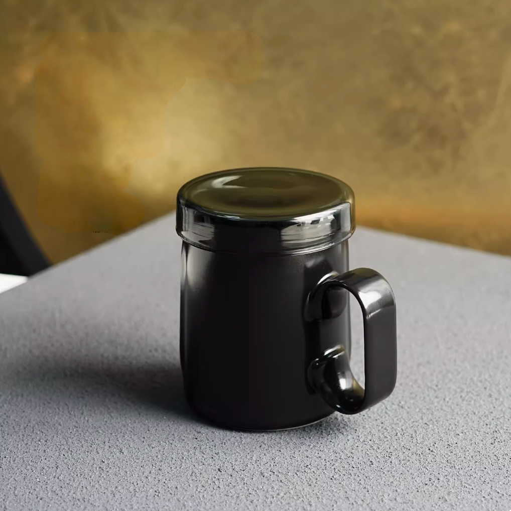 Black Ringmug ceramic mug with lid, front view highlighting glossy finish, ring handle, and modern design