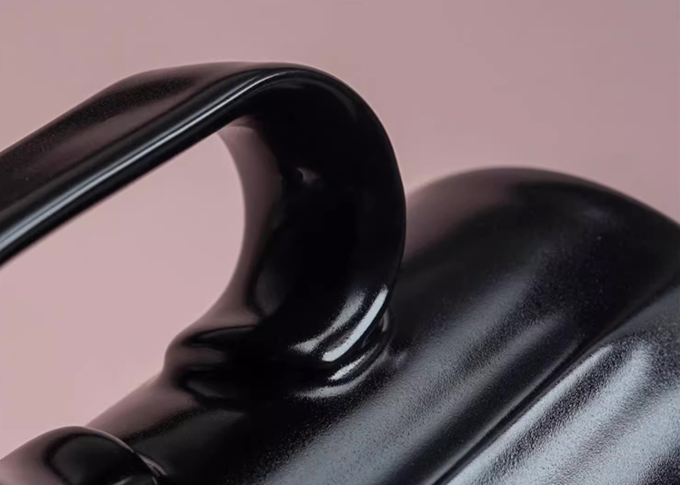Close-up of Black Ringmug ceramic mug handle showing curved ergonomic grip and smooth glazed texture