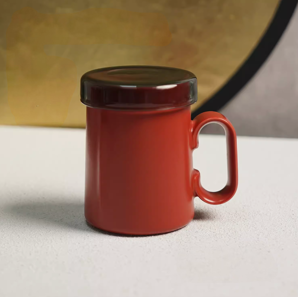 Red Ringmug ceramic mug with lid attached, front view highlighting ring handle and minimalist cylindrical shape