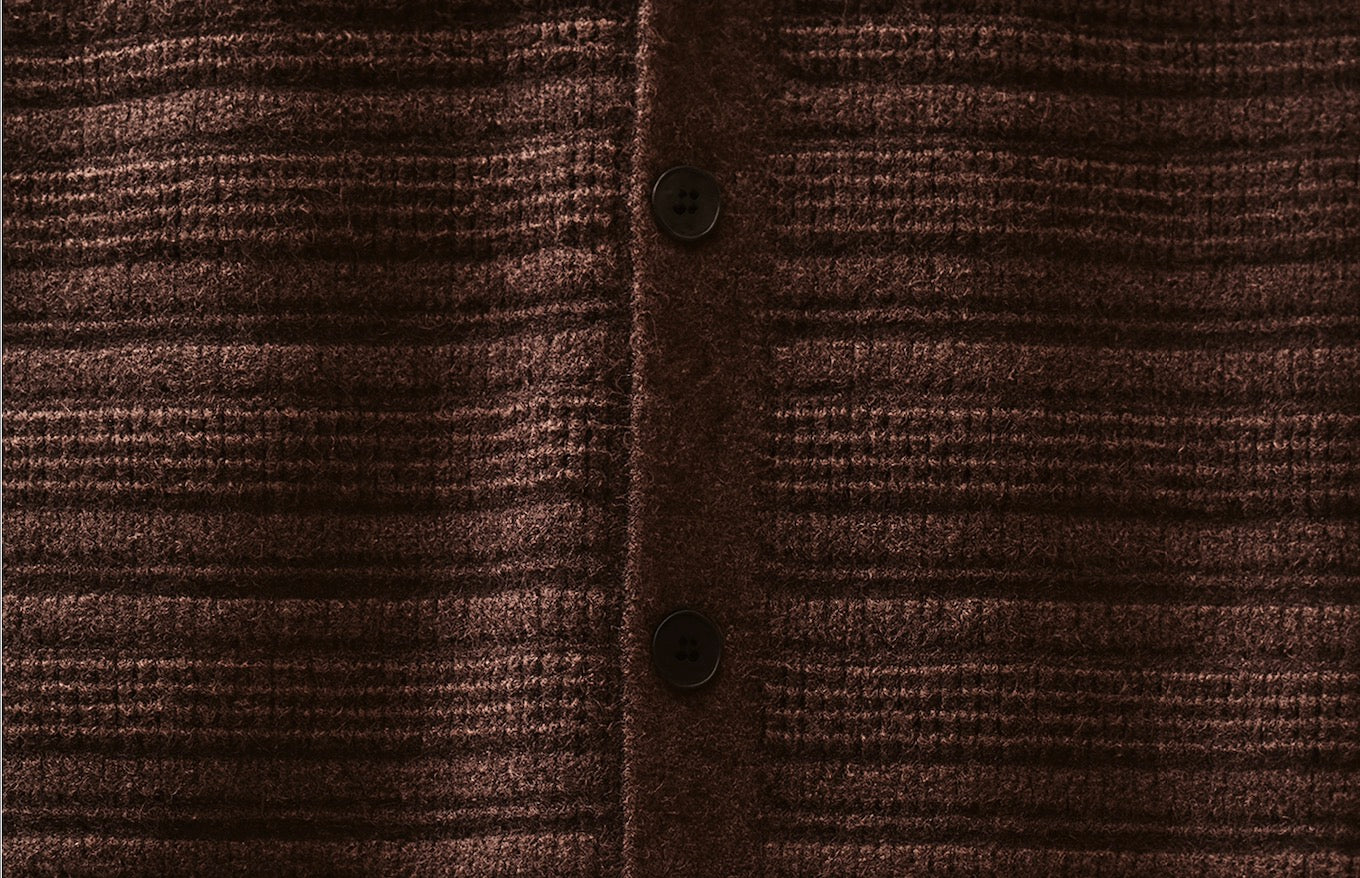 Brown ripple knit cardigan button placket close-up with textured knit pattern
