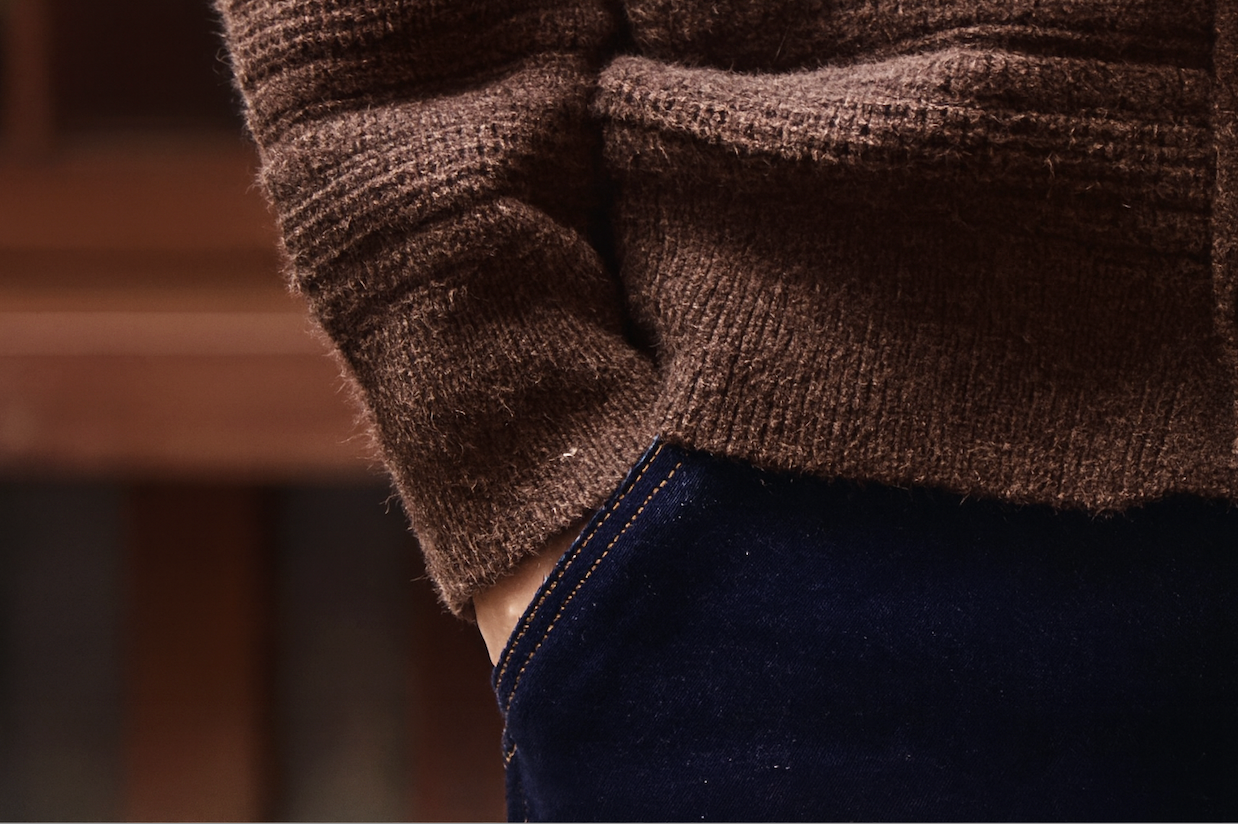 Ribbed cuff and hem detail on brown ripple knit cardigan with relaxed fit