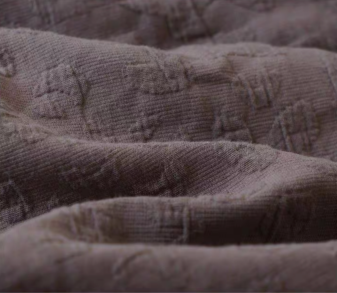 Close-up of Rock Point cotton bedding in Leopard Print Coconut Brown showing natural textured cotton weave