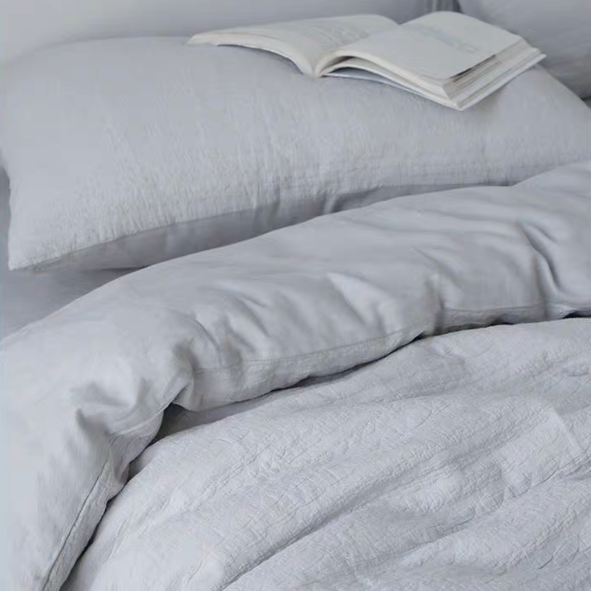 Rock Point white cotton comforter draped naturally across bed with matching pillow shams