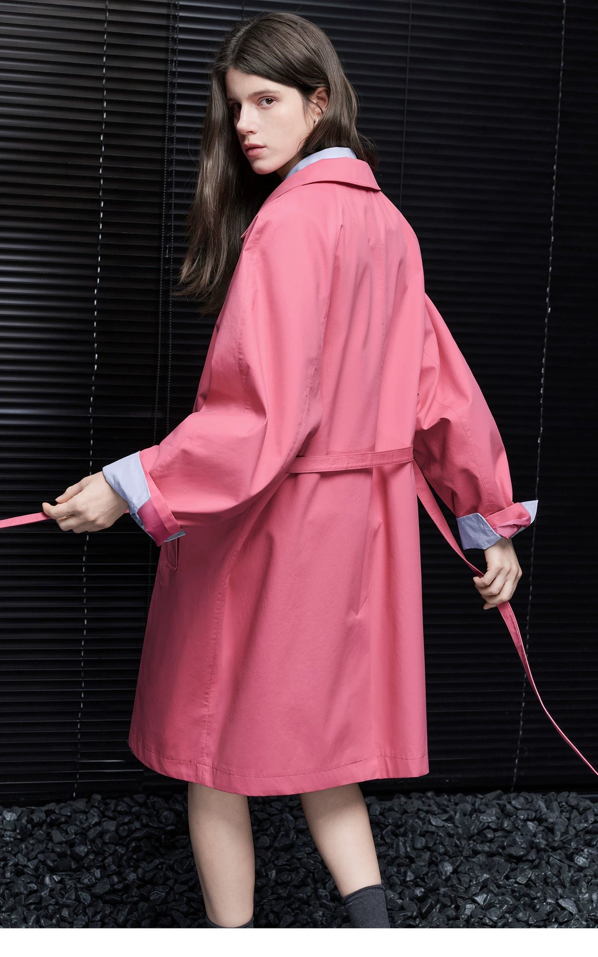 Back view of a Rose Pink cotton trench coat with raglan sleeves and an untied self-belt