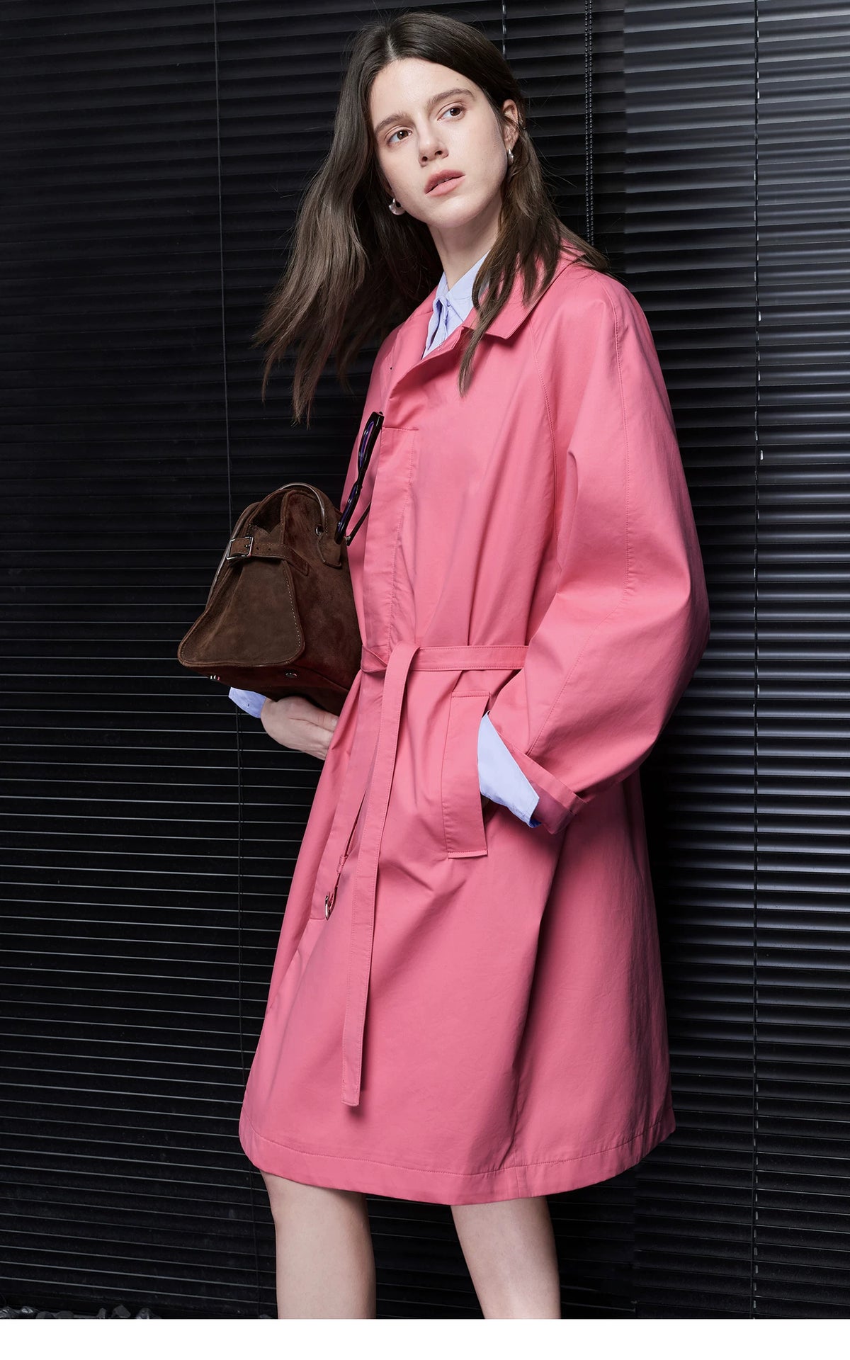 Side view of a Rose Pink cotton trench coat with tied belt, chest pocket, and in-seam side pocket