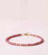 Rose rhodonite delicate bracelet in soft pink tones displayed flat with evenly arranged natural stone beads and gold clasp detail