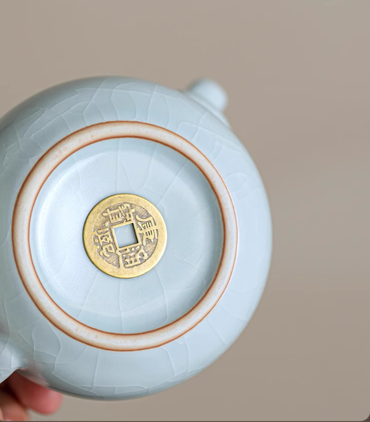 Bottom view of Ru Kiln Celadon Mini Teapot in light blue showing base mark and crackle glaze texture