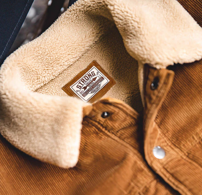 Close-up of Rust Corduroy Trucker Jacket with Sherpa Collar in Ginger Yellow highlighting sherpa lining corduroy texture and inner label