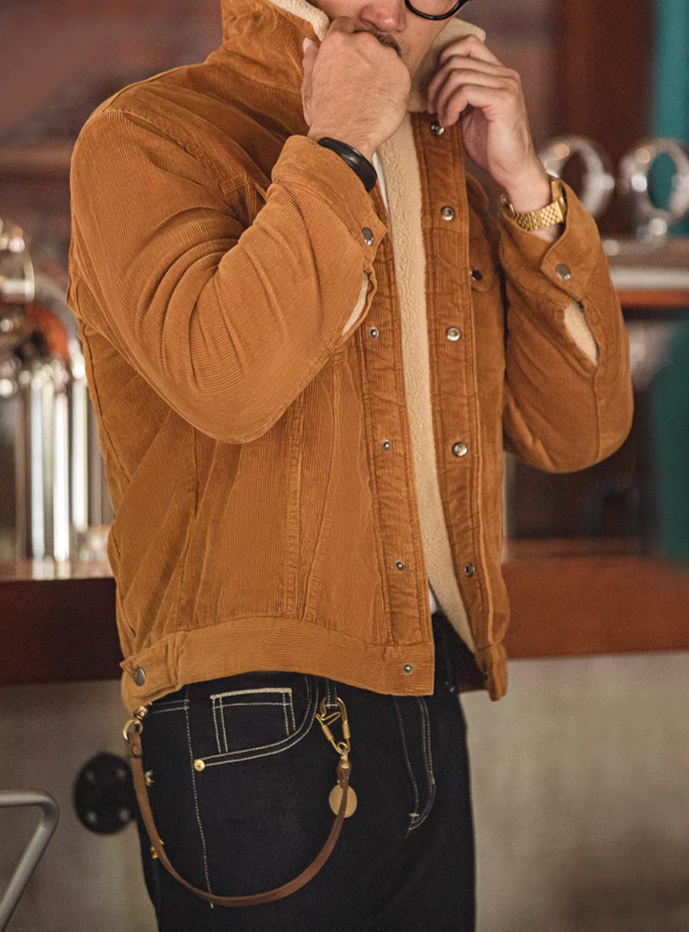 Side view of Rust Corduroy Trucker Jacket with Sherpa Collar in Ginger Yellow with model adjusting collar showing sherpa lining