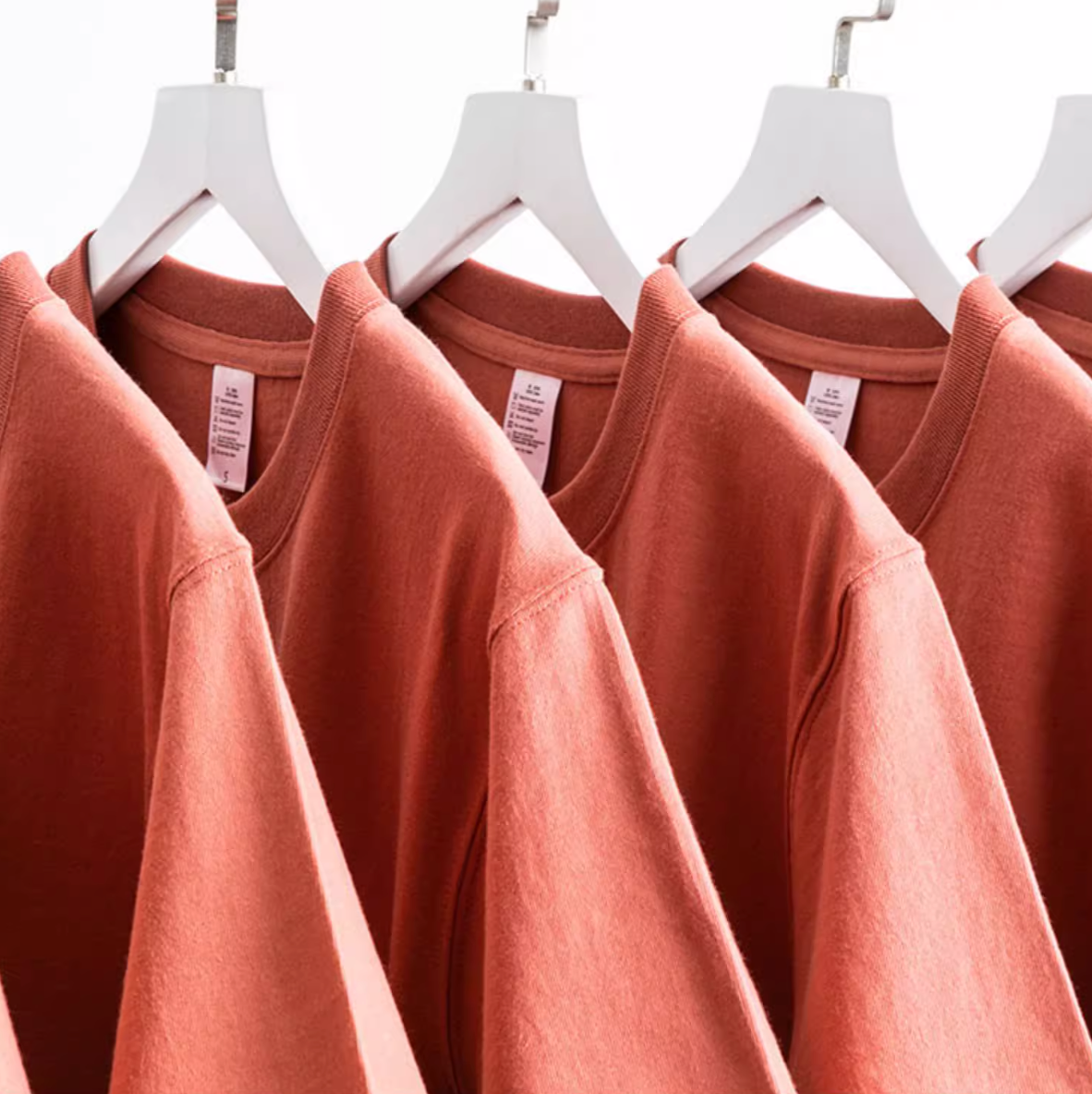 Rustic T-Shirt red multiple shirts hanging on rack showing relaxed fit and soft cotton fabric