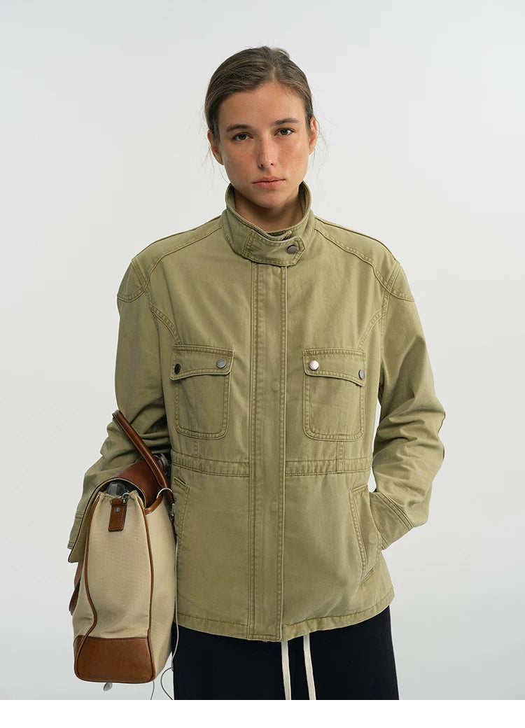 Sage green cotton field jacket zipped up with two snap-flap chest pockets, front view