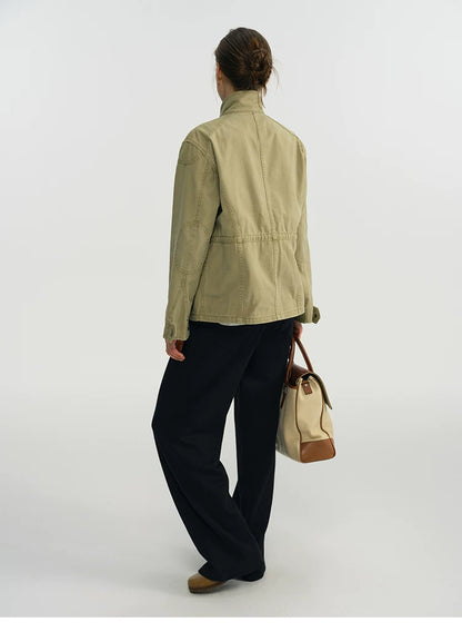 Back view of a sage green field jacket with topstitched panel seams
