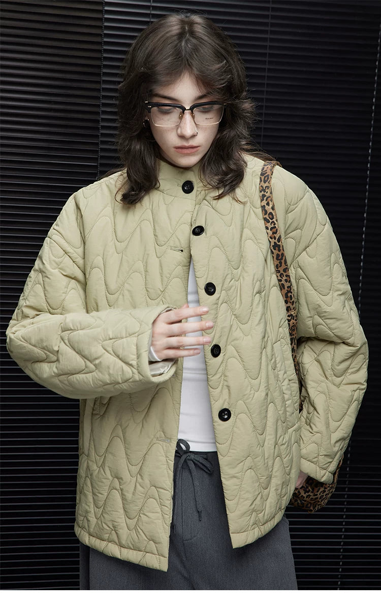 Close-up of a Sage Green wave-quilted down jacket&