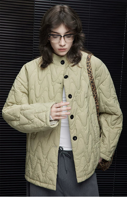 Close-up of a Sage Green wave-quilted down jacket&