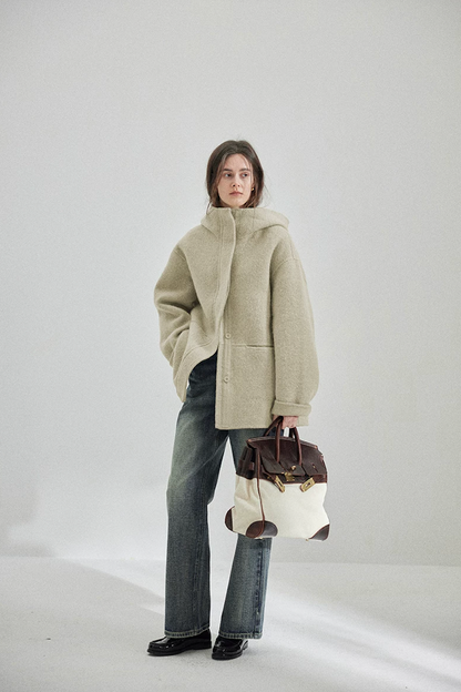 Full-length view of a Sage hip-length hooded wool coat with straight hem
