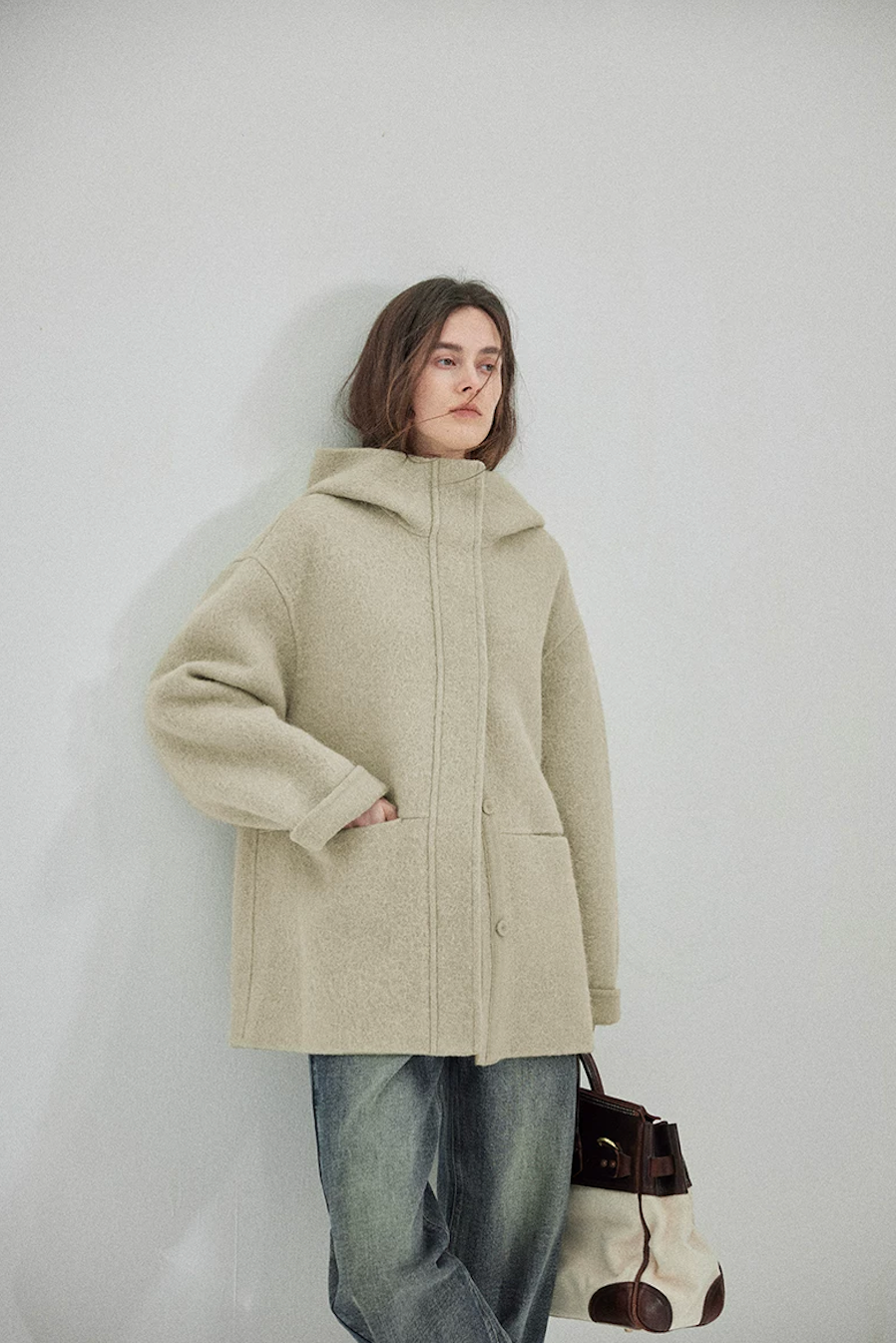 Sage hooded double-face wool coat with stand collar, concealed placket, and rolled cuff