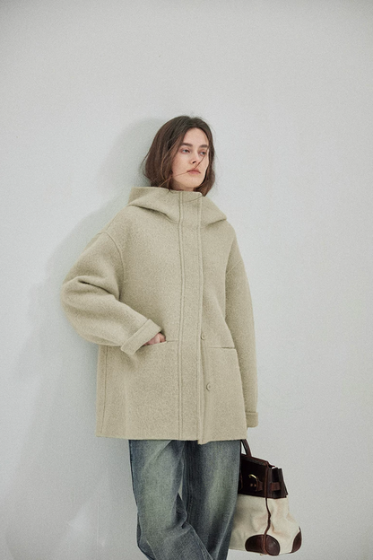 Sage hooded double-face wool coat with stand collar, concealed placket, and rolled cuff