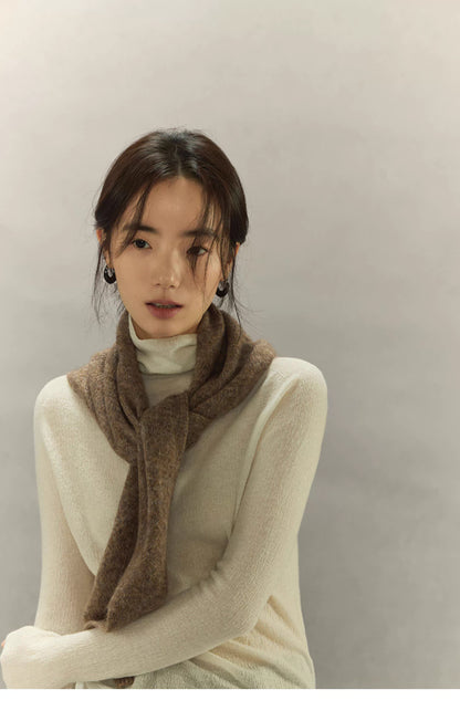 woman wearing light coffee brown knit scarf tied loosely around neck