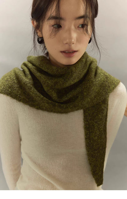 woman wearing moss green knit cashmere wool scarf wrapped around neck