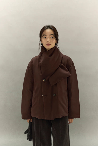Minimal front shot of double-breasted scarf puffer jacket in dark coffee brown