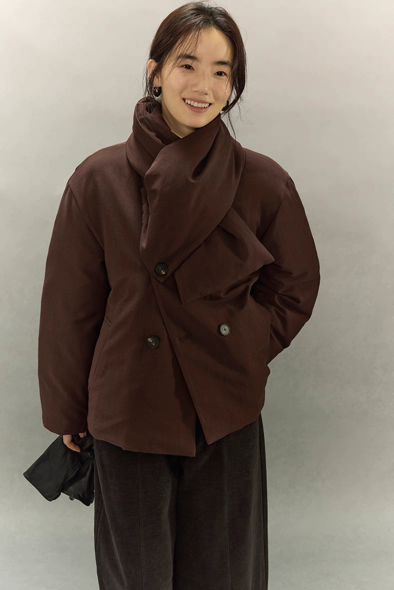 Woman smiling in dark coffee brown scarf puffer jacket with scarf draped across chest