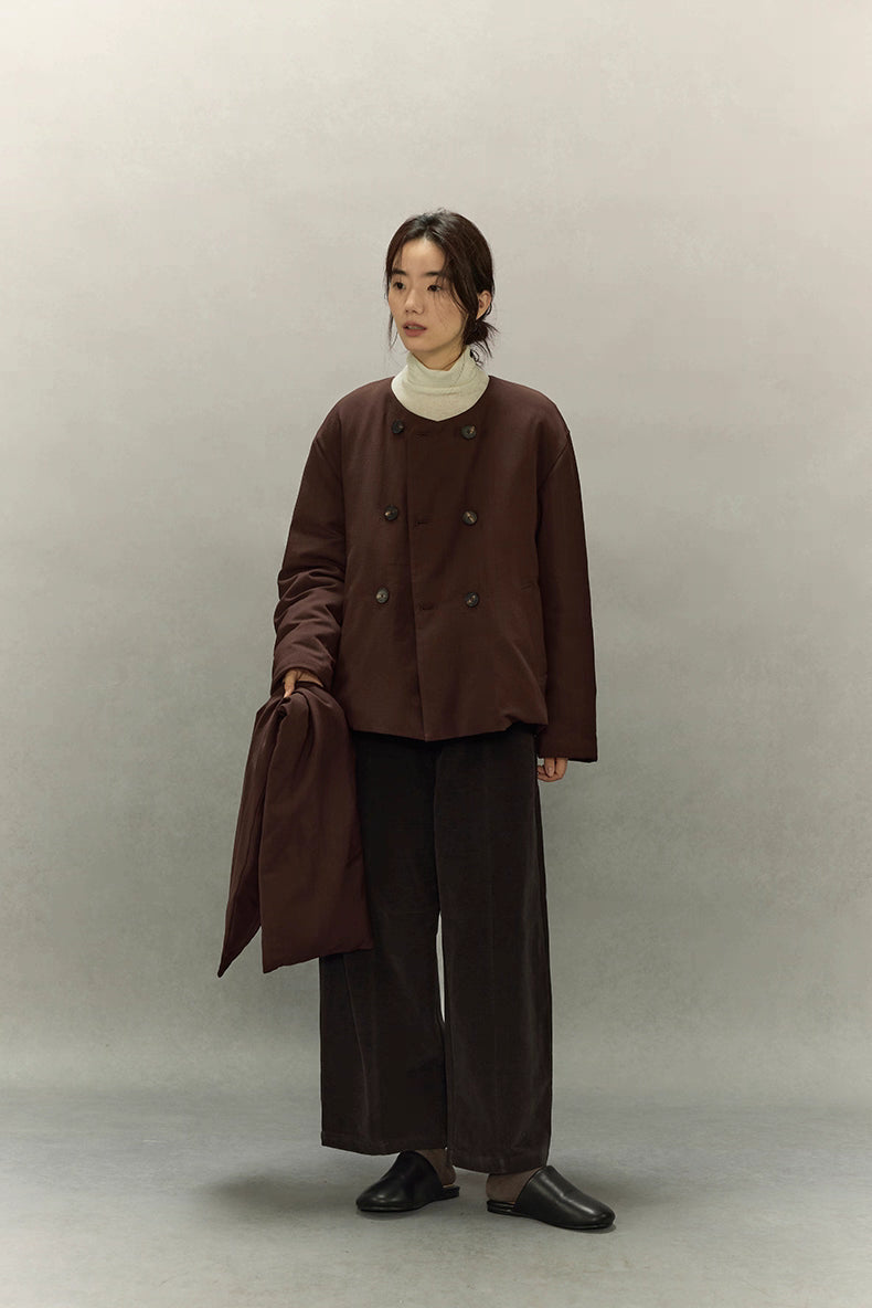 Full body view of woman holding matching scarf with cropped scarf puffer jacket