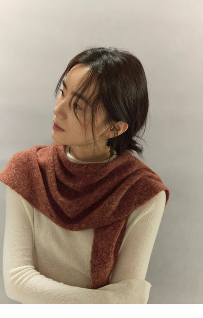 woman looking upward while wearing rust brown cashmere wool scarf