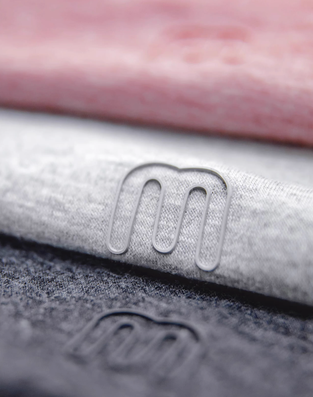 Seamless Breathable Lightweight Tee multi color close-up showing fabric blend texture and small logo detail on Dusty Pink Light Gray Coffee and Dark Gray tees
