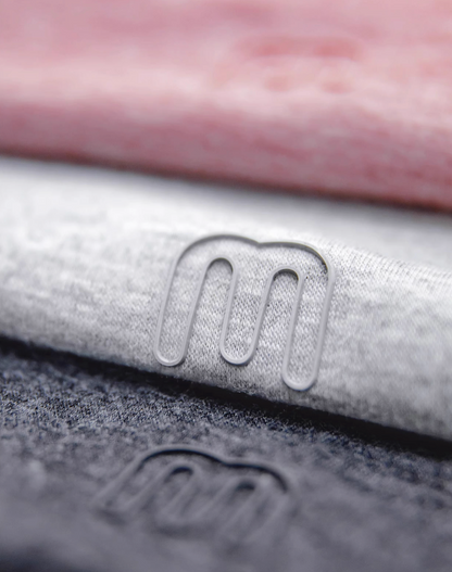 Seamless Breathable Lightweight Tee multi color close-up showing fabric blend texture and small logo detail on Dusty Pink Light Gray Coffee and Dark Gray tees
