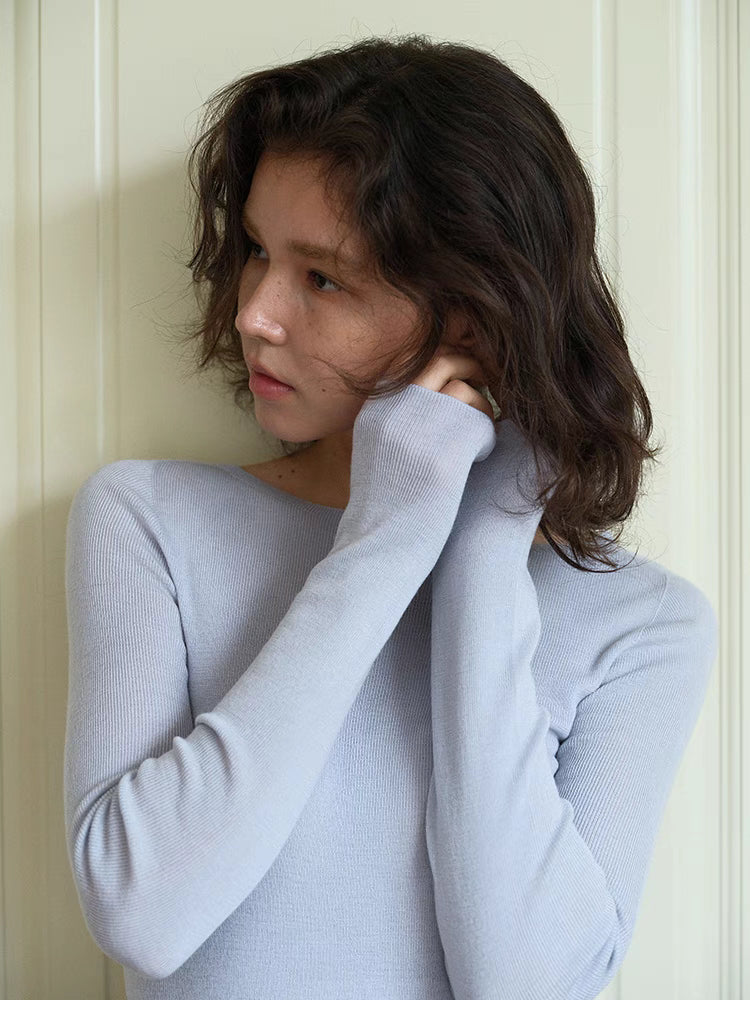 Close-up of light blue seamless sculpt merino sweater showing fine knit texture and fitted sleeve detail