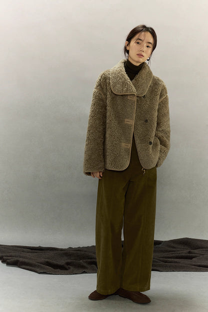 Full-body front view of woman wearing sherpa textured wool jacket