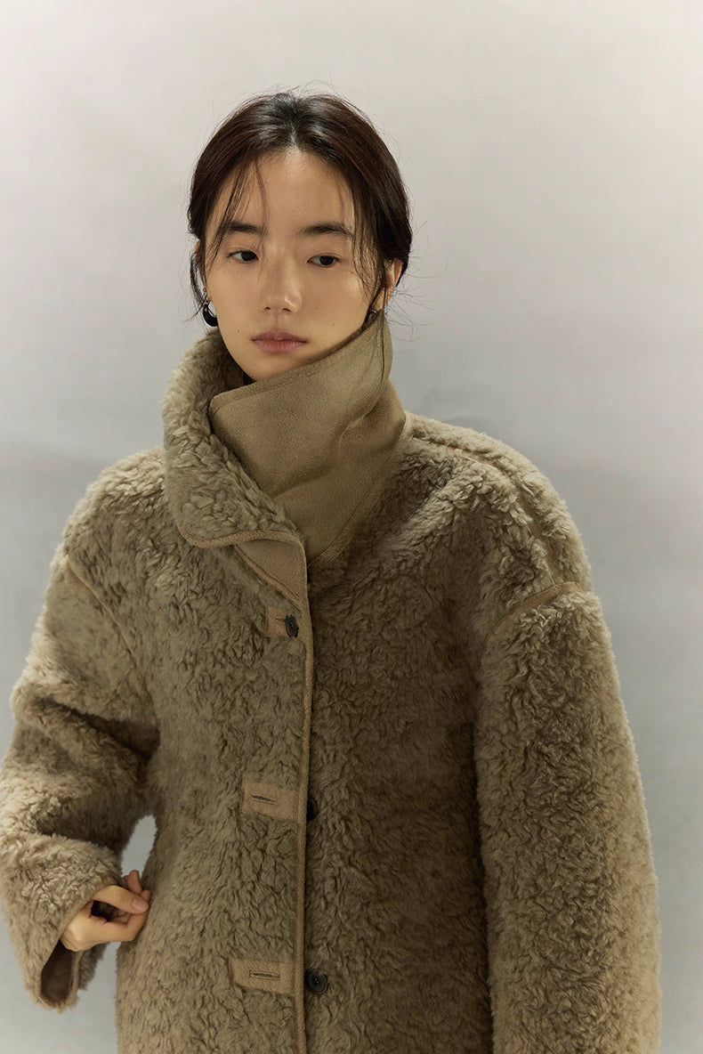 Sherpa wool jacket shown with high collar buttoned up for warmth