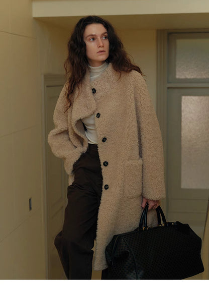 Full-body look of Sierra Luxe Shearling Coat in beige apricot styled for winter, featuring relaxed silhouette, longline design, and plush warmth